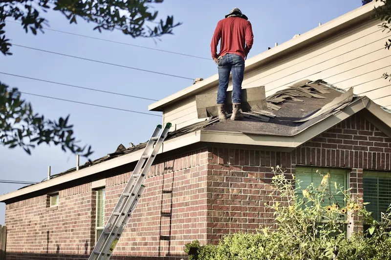 Professional roofer working on a residential roof in Falcon Park